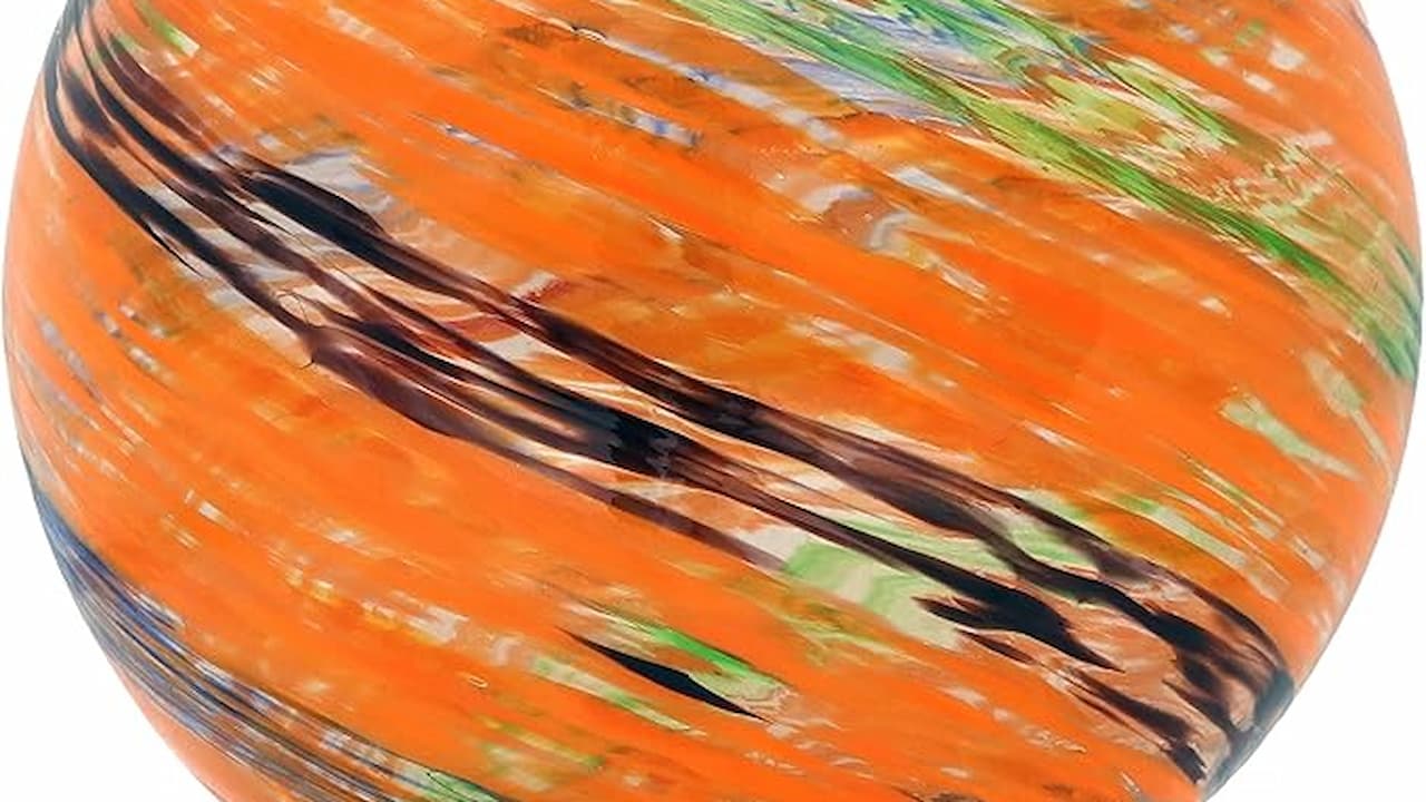 Hand-blown glass globe with swirling orange, green, black, and white patterns, smooth glossy surface, spherical shape