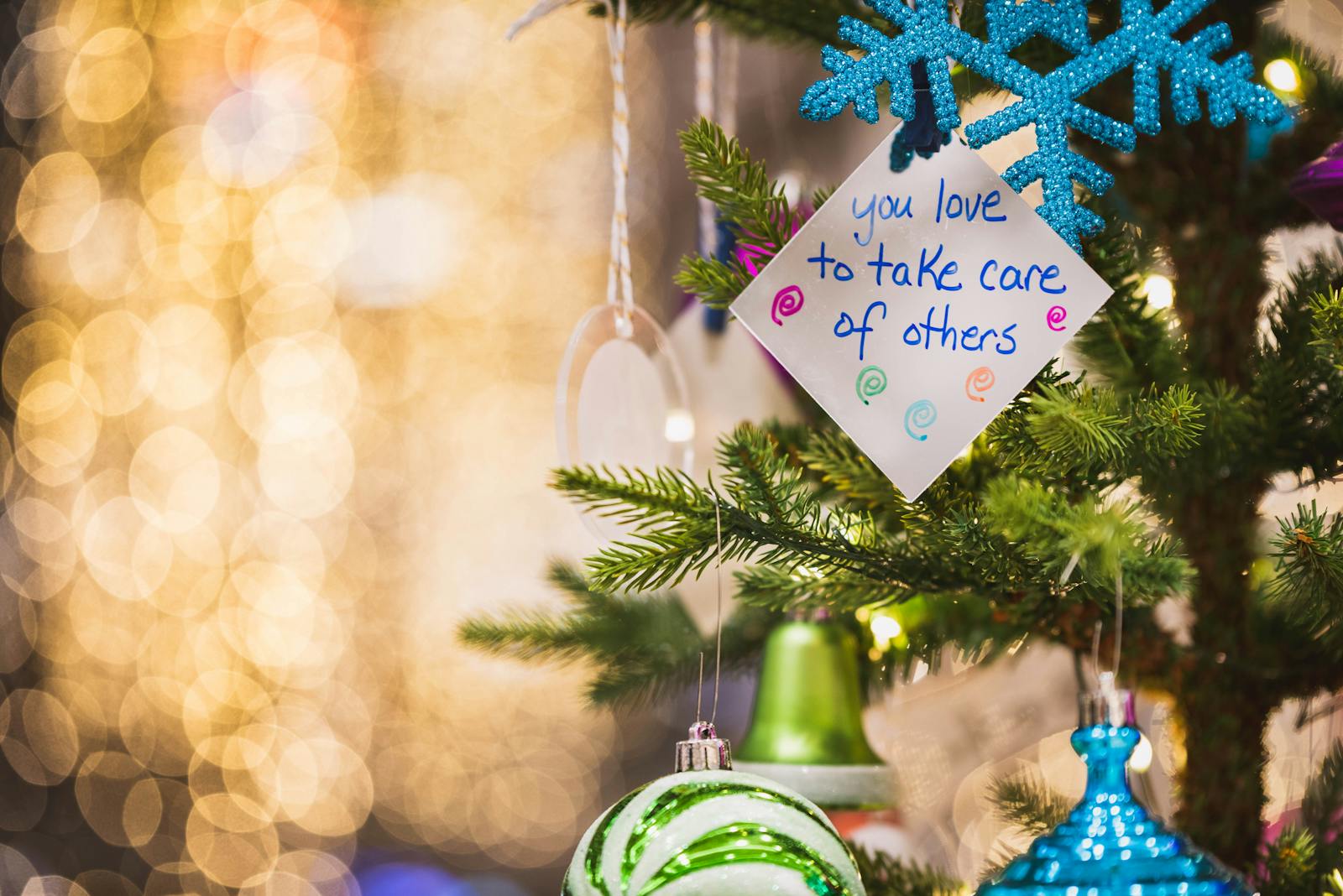 Close-up of a decorated Christmas tree with notes and ornaments, perfect for holiday themes.