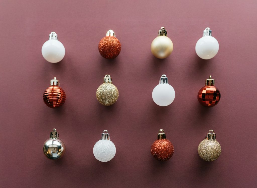 A group of christmas ornaments on a purple surface