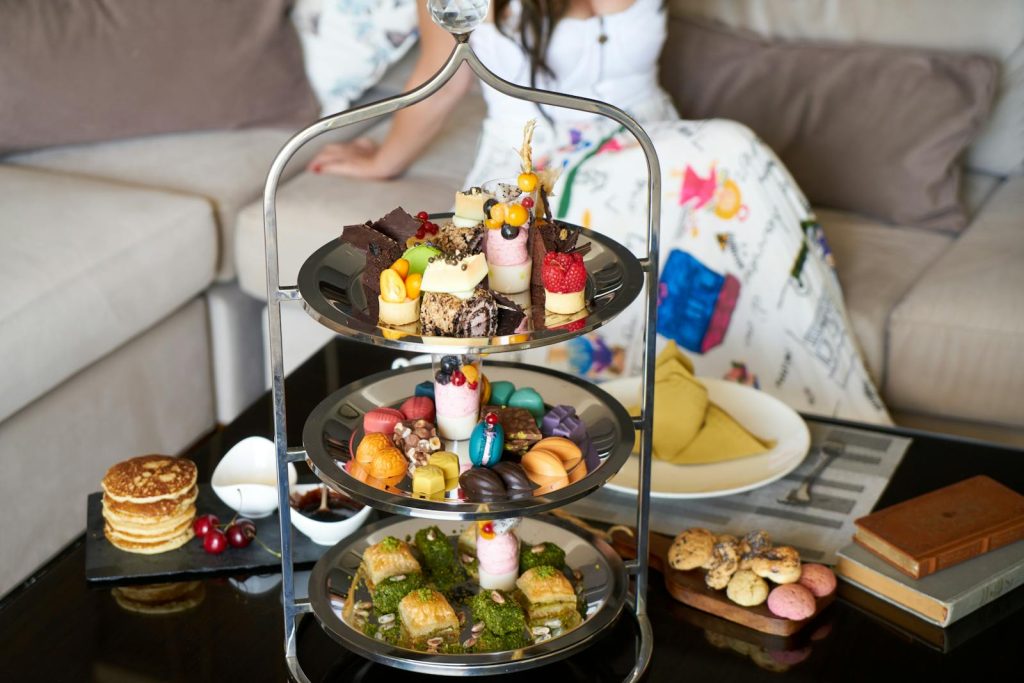 Luxurious three-tier dessert stand with colorful sweets and pastries, perfect for afternoon tea gatherings.