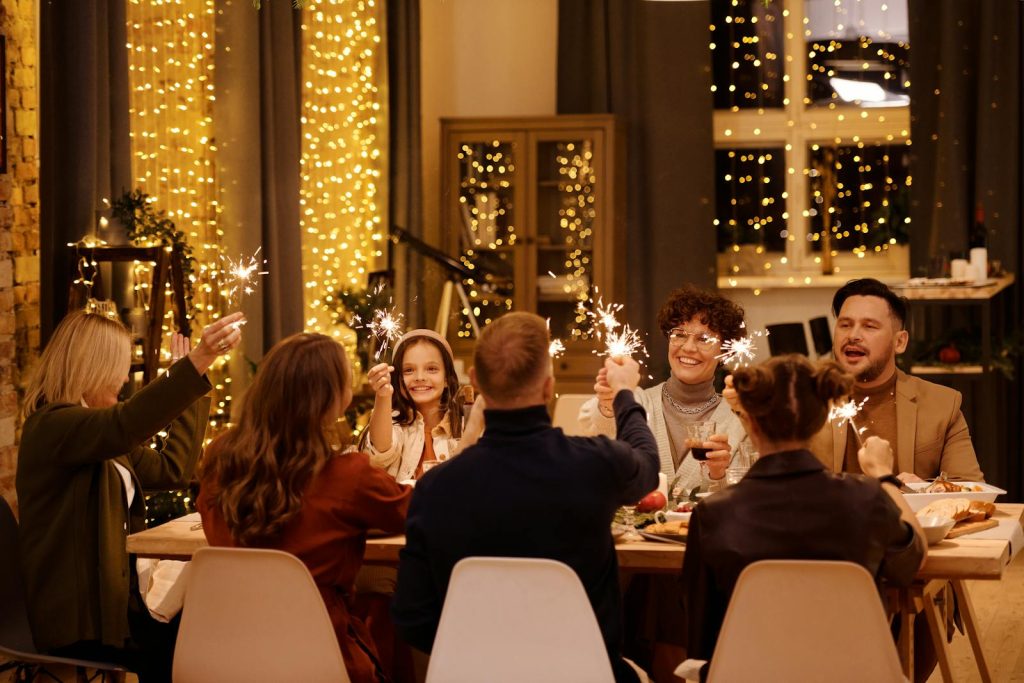 A cheerful family dinner with sparklers, creating a festive atmosphere.
