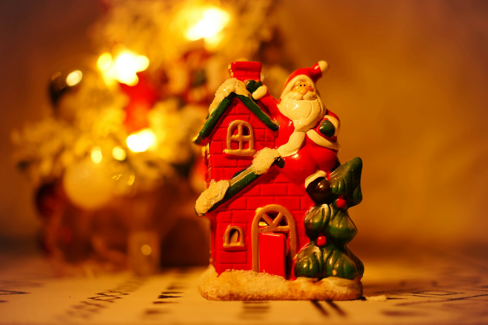 a christmas scene of a house with a santa clause on the roof