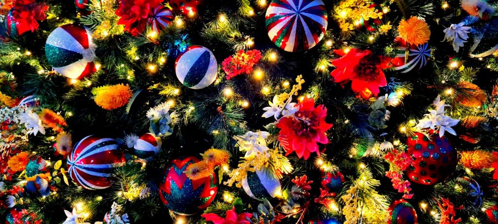 a christmas tree is decorated with colorful ornaments