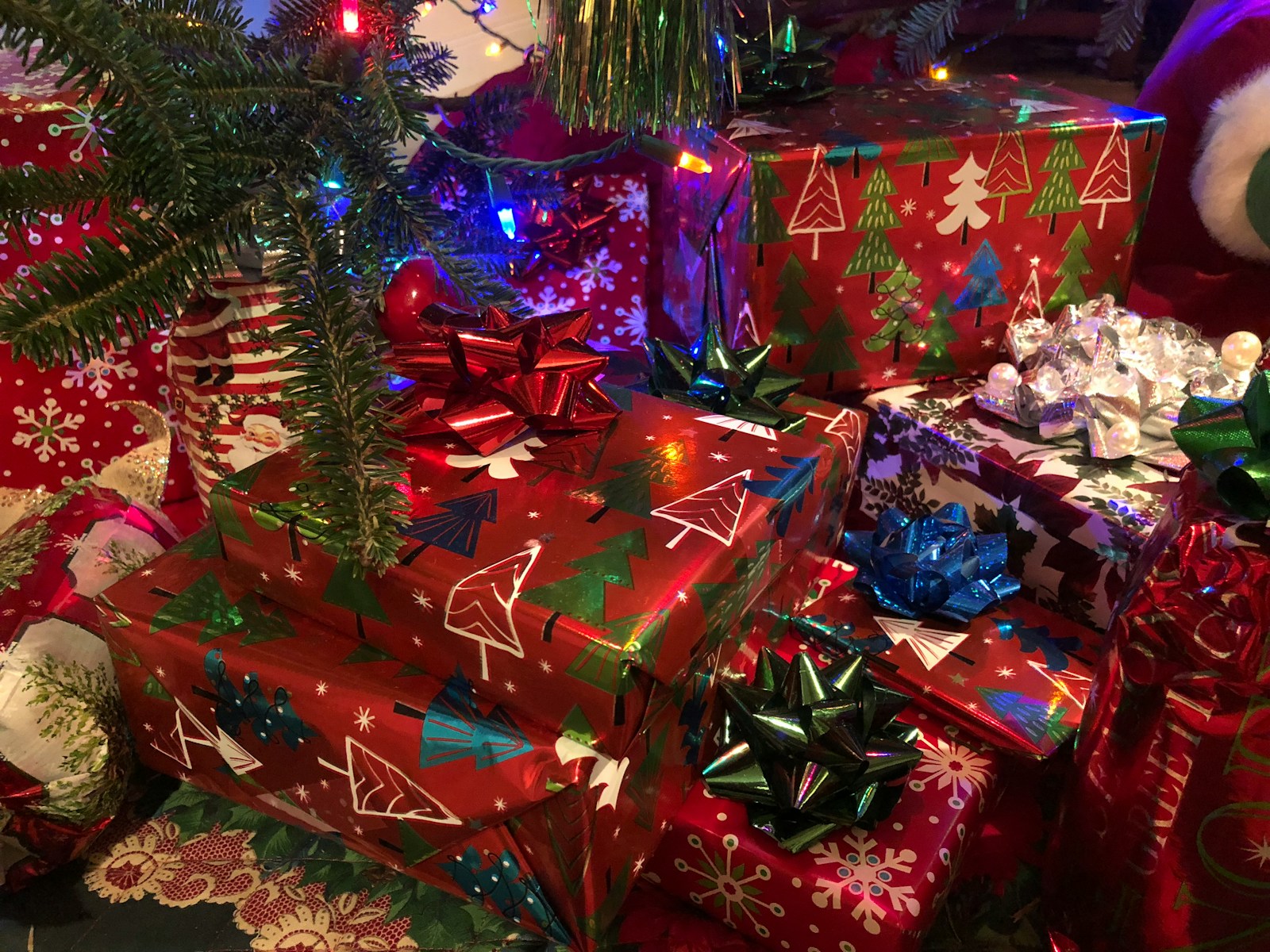assorted-colored gift boxes near Christmas tree