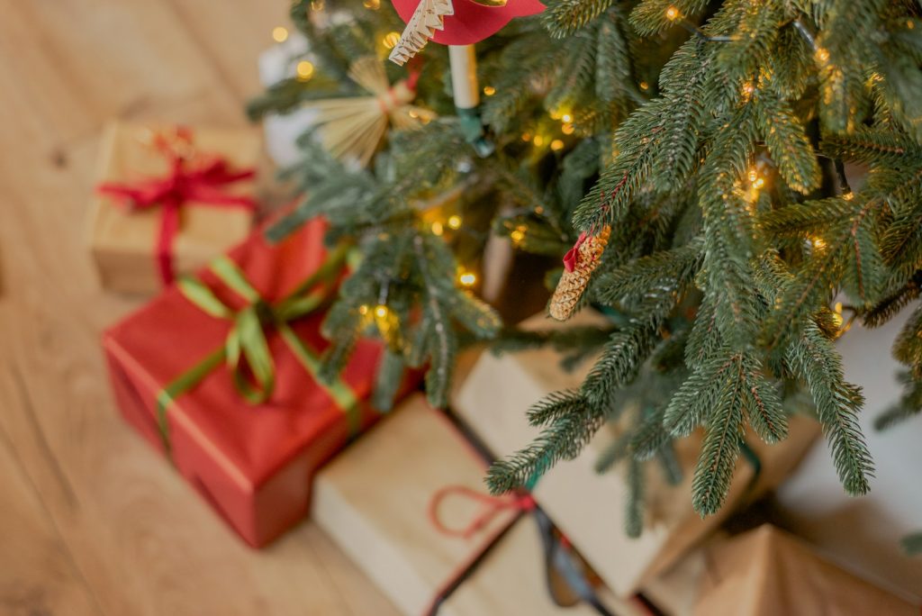 a small christmas tree with presents under it