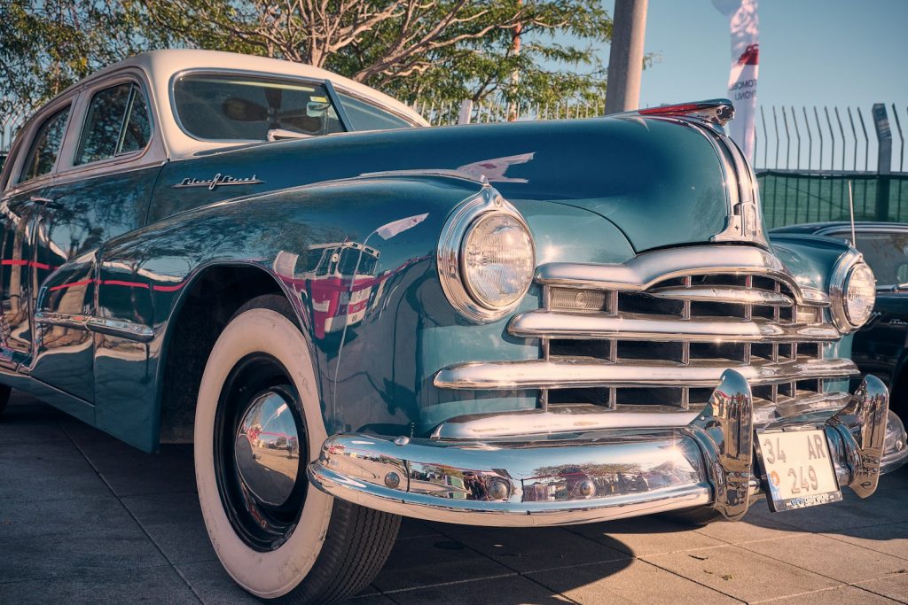 a classic car parked on the side of the road