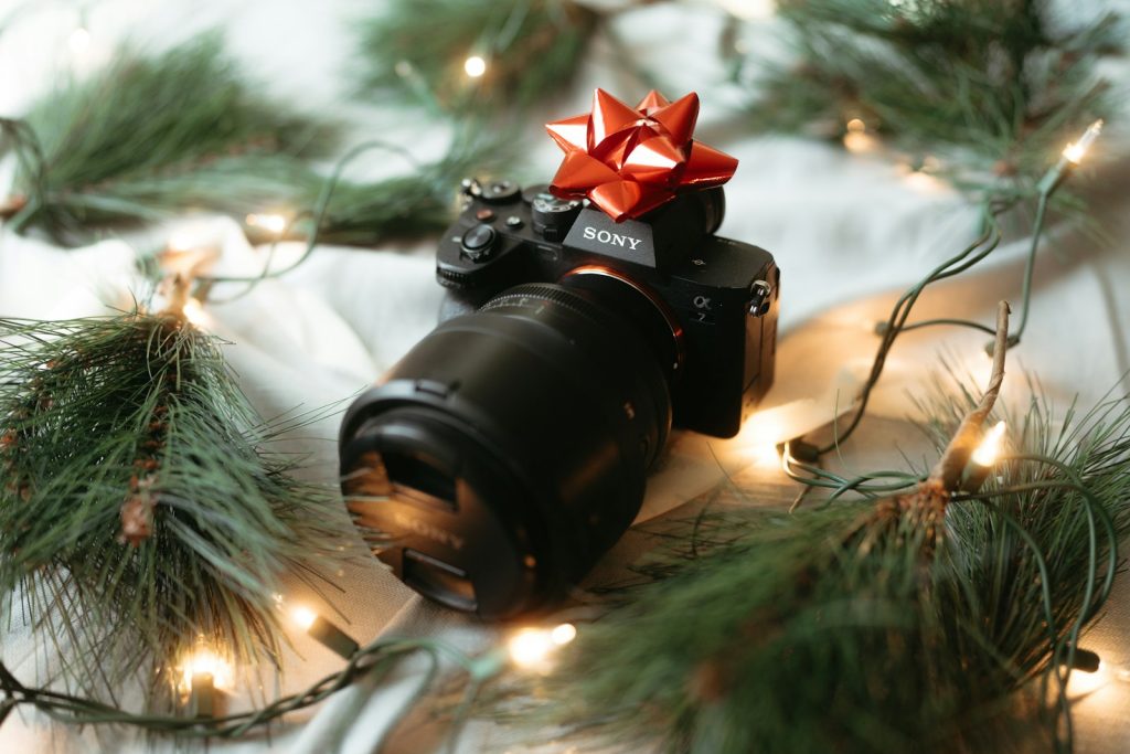 A camera sitting on top of a table covered in christmas lights