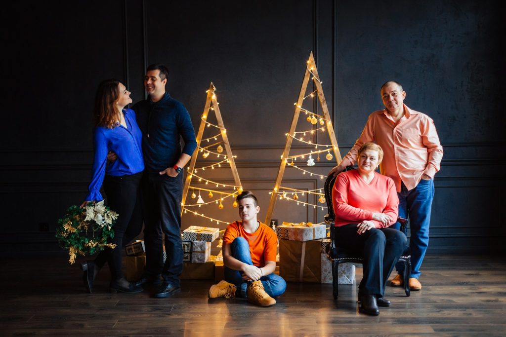 a group of people standing and sitting next to each other