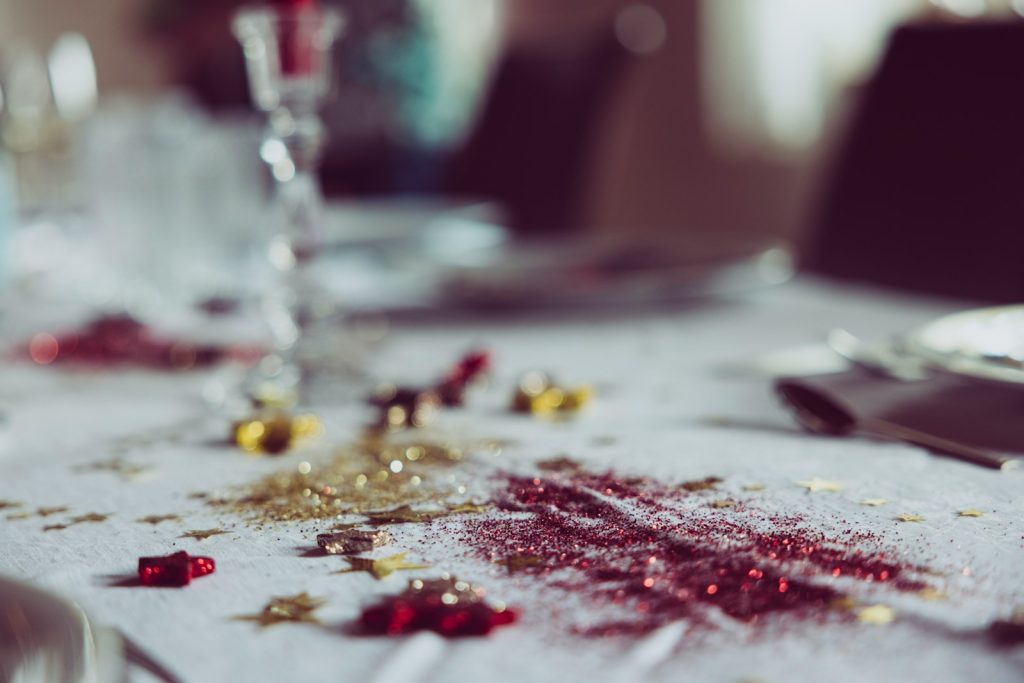 a table topped with a white table cloth covered in confetti