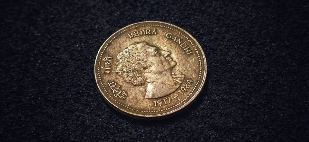 A coin is shown on a black surface