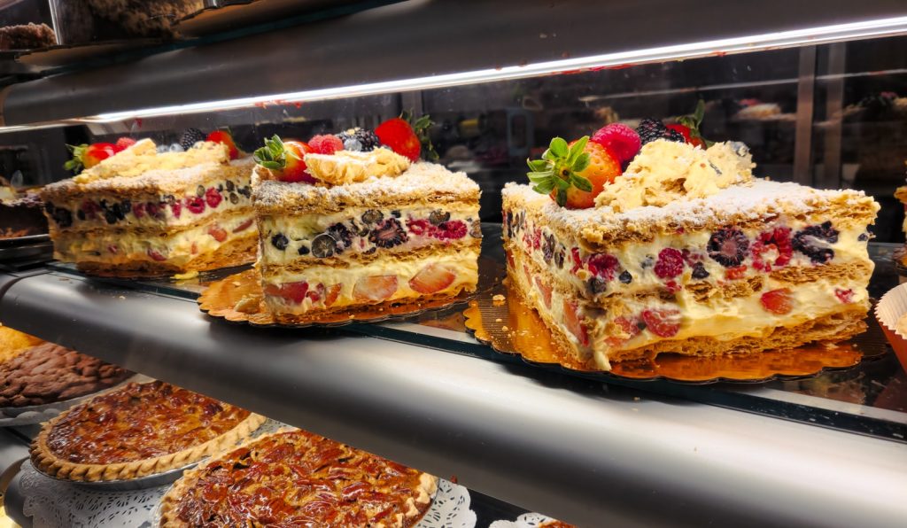 A display case filled with lots of different types of desserts