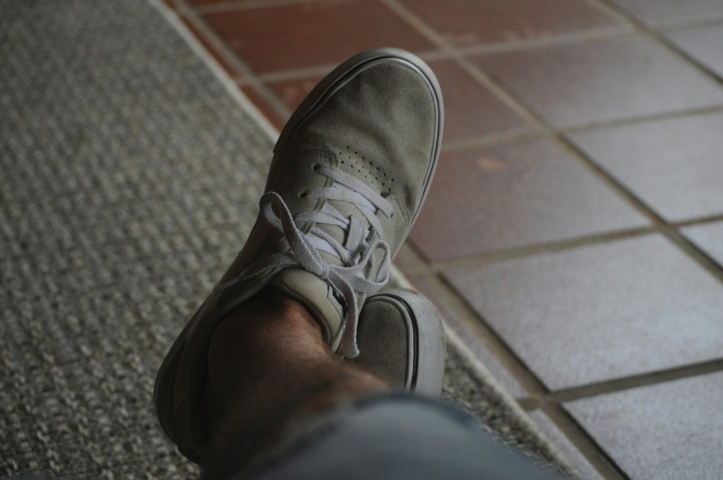 person wearing gray nike sneaker