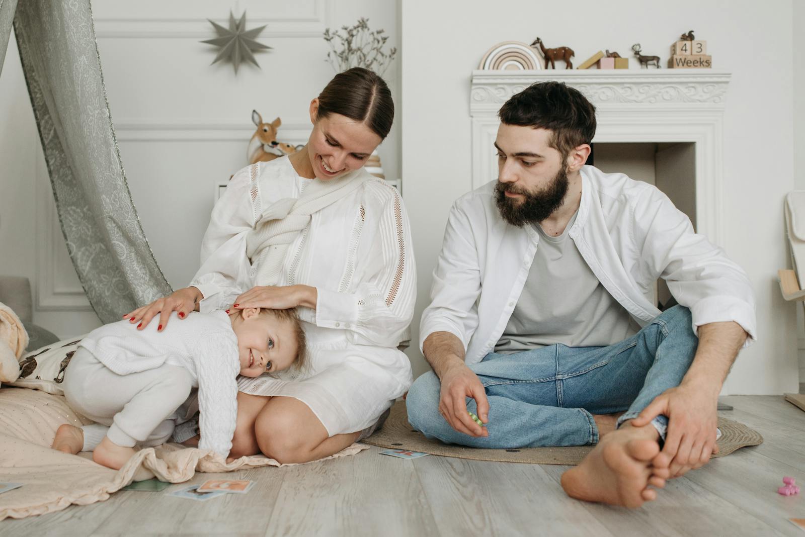 A joyful family moment with parents and child enjoying together indoors.