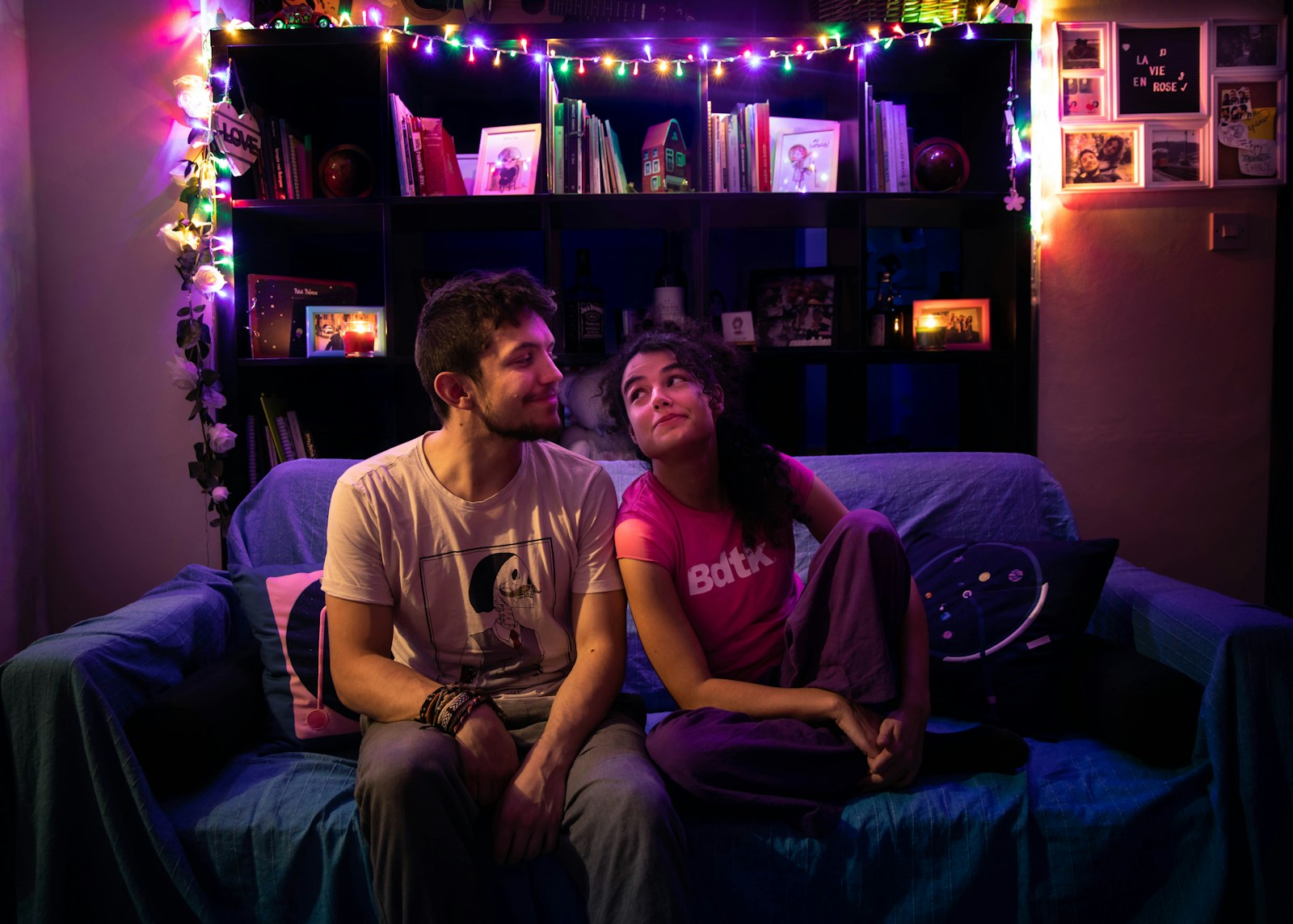 man in white crew neck t-shirt sitting beside woman in gray crew neck t-shirt