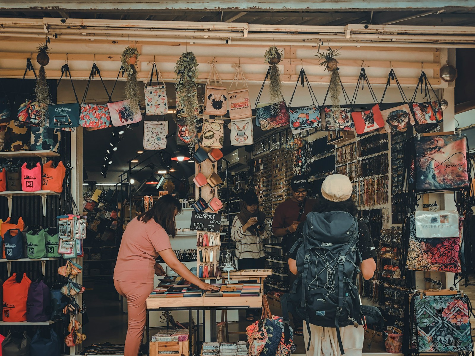 woman in pink top standing beside table