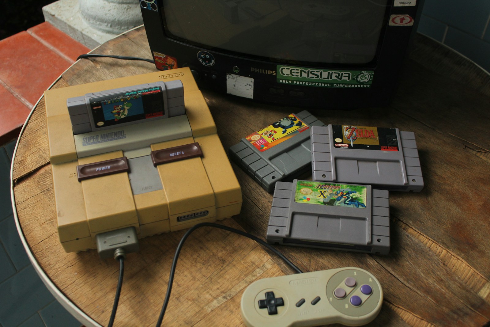 a table topped with nintendo game controllers and a tv