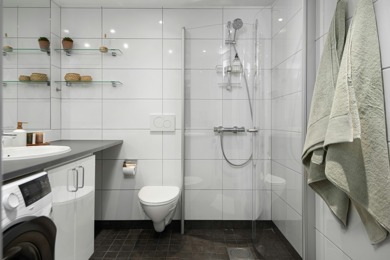 A bathroom with a washer and dryer in it