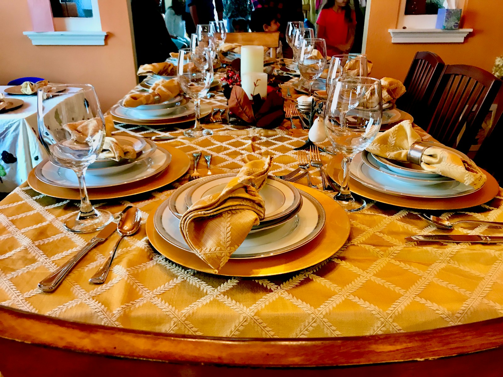 a table set for a formal dinner with plates and silverware