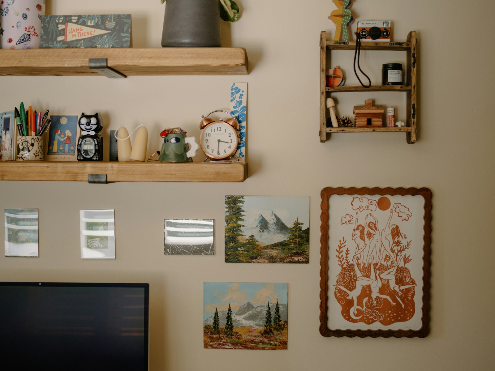 Wall decorated with shelves, art, and small objects.