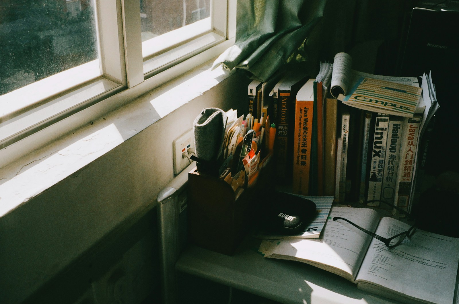 Books and glasses on a table by the window