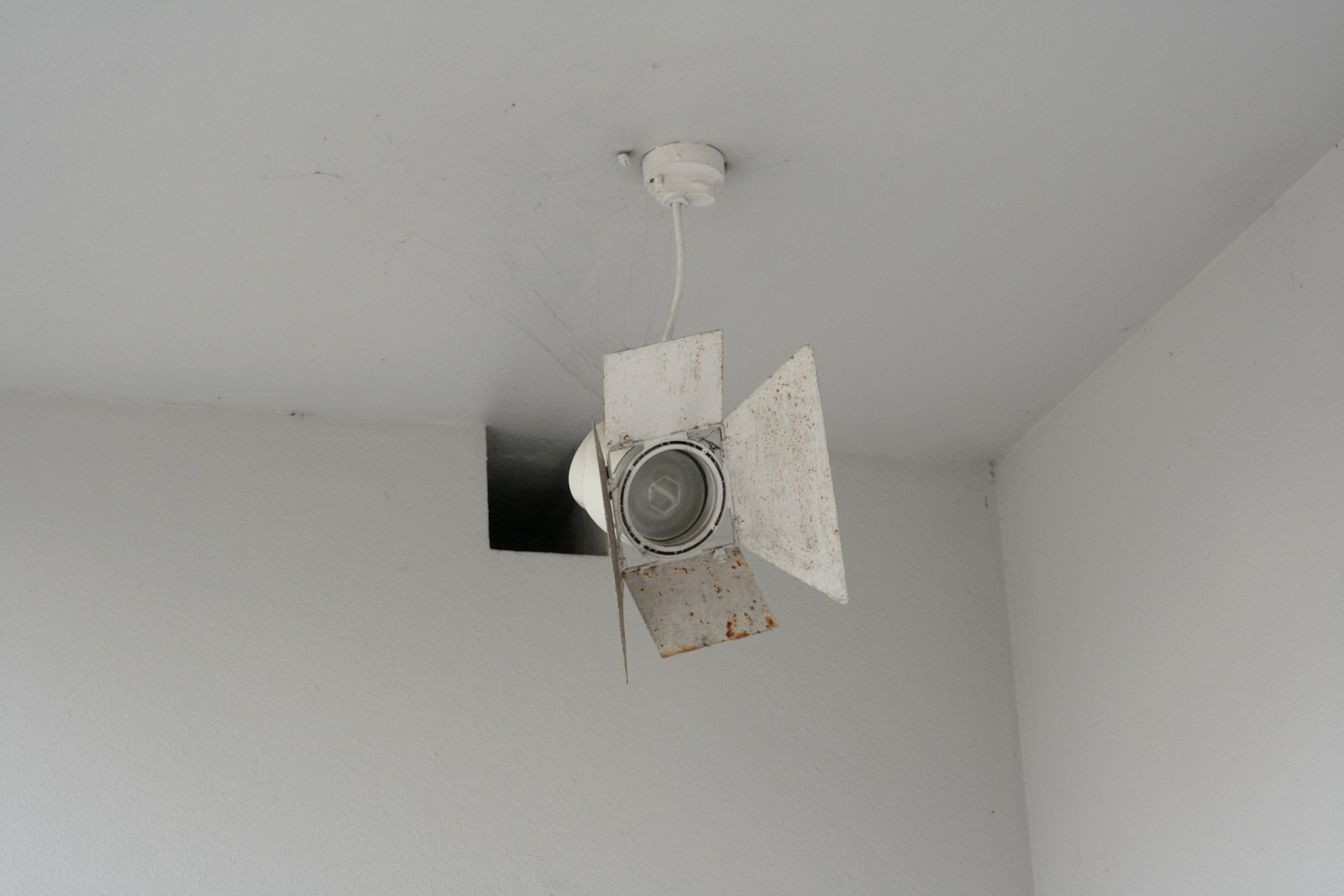 a ceiling fan is hanging from the ceiling of a room