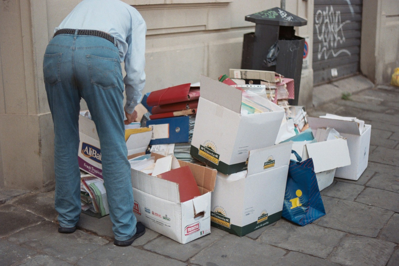 A man standing next to a pile of boxes