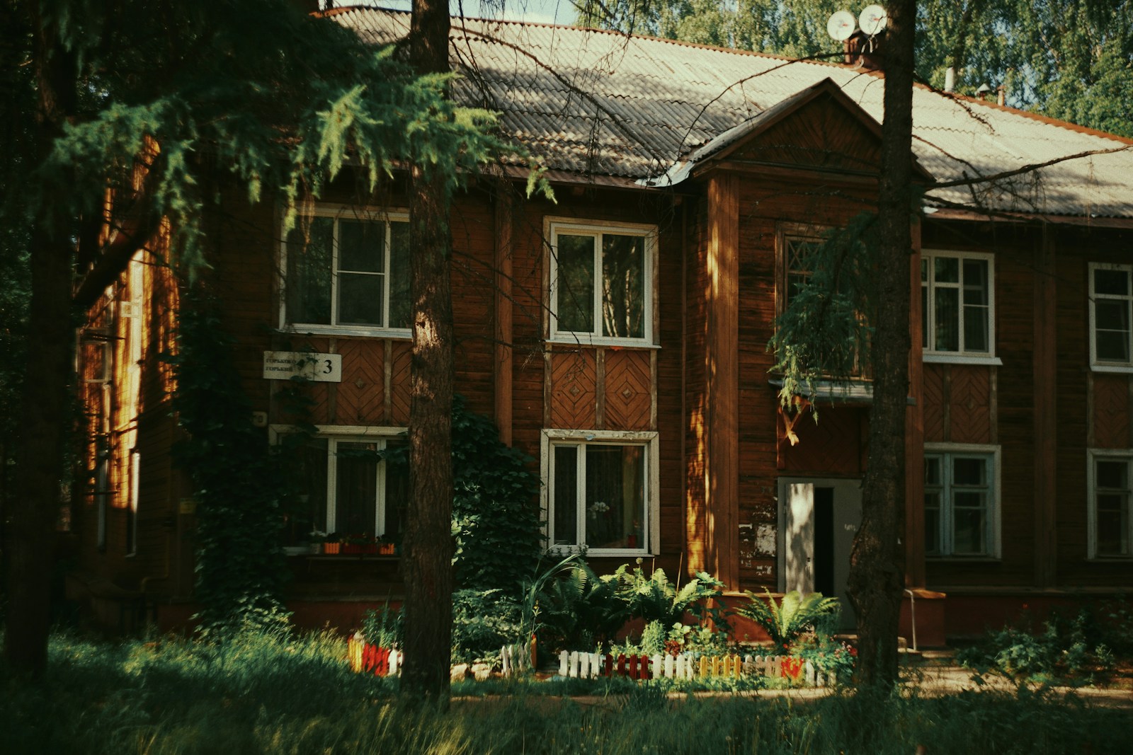 a large brick building with trees in front of it
