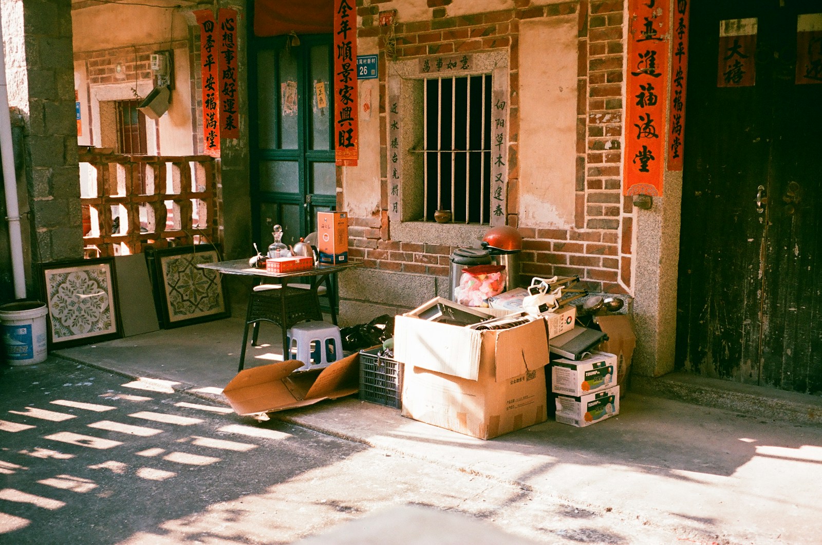 Old building exterior with stacked boxes and items.