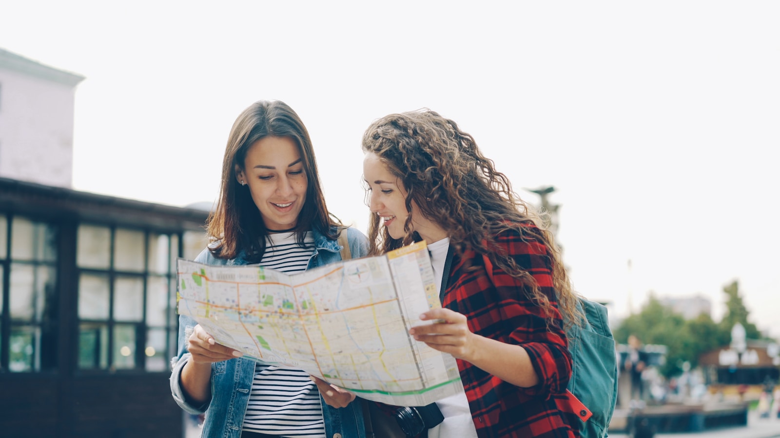 Two women are looking at a map together.