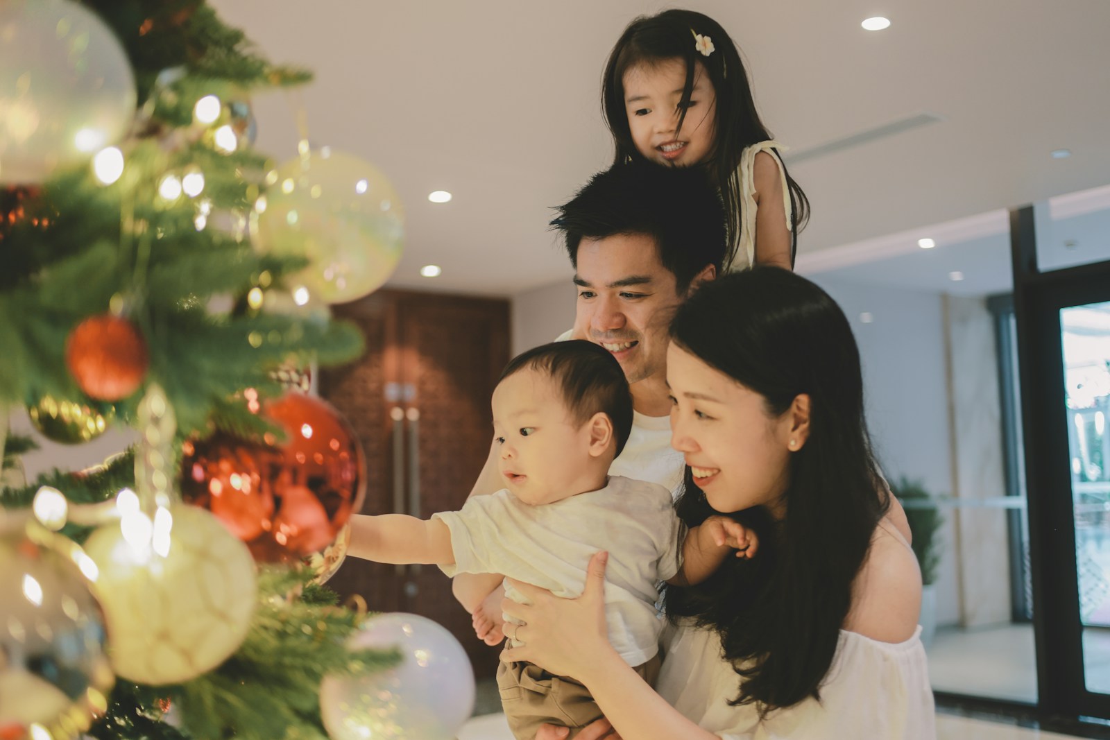 Family decorating a christmas tree together