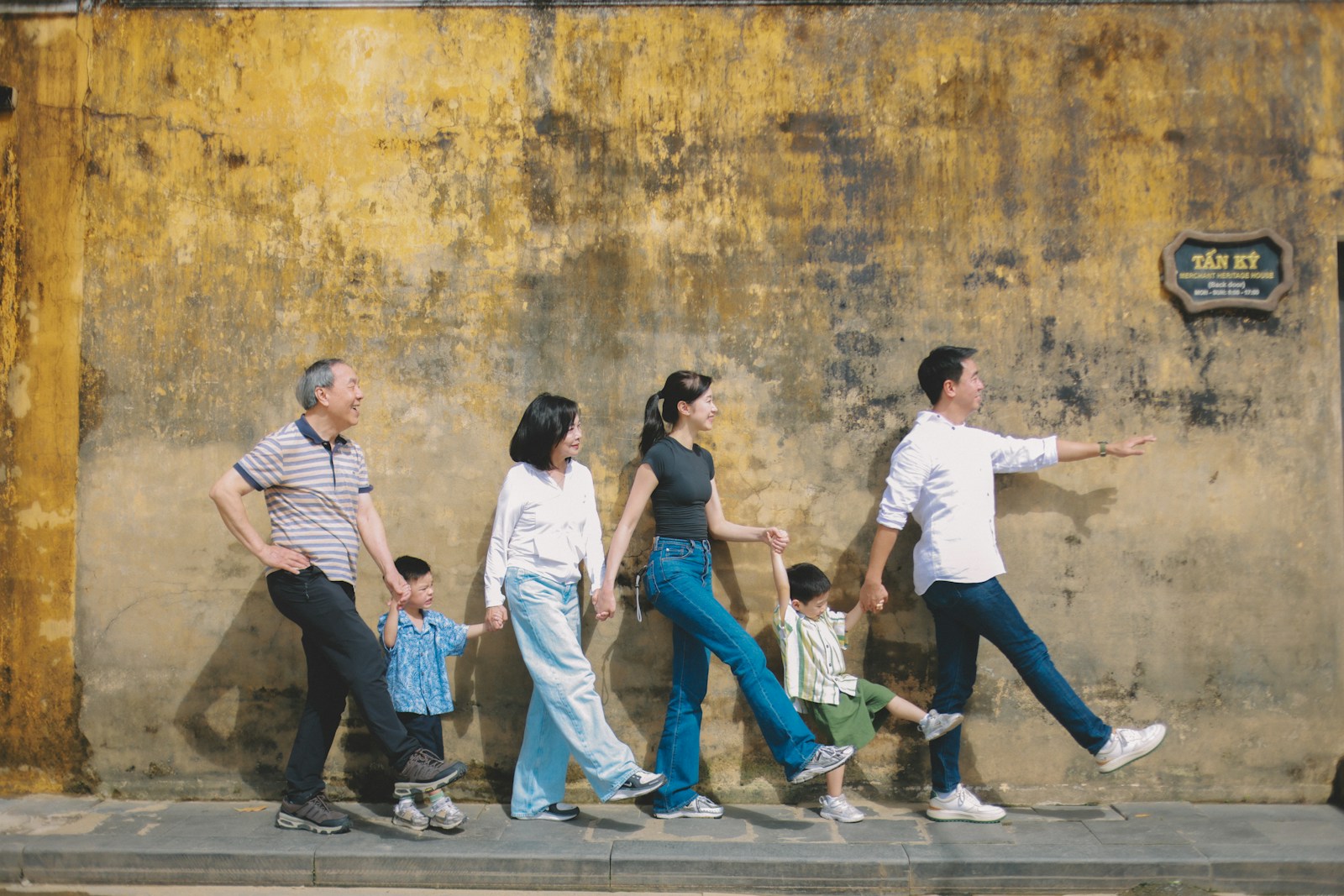 Family walking together against textured wall