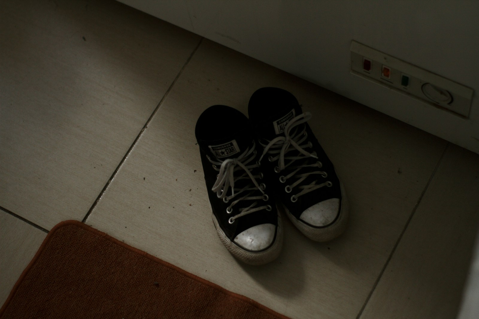 a pair of black and white tennis shoes on the floor