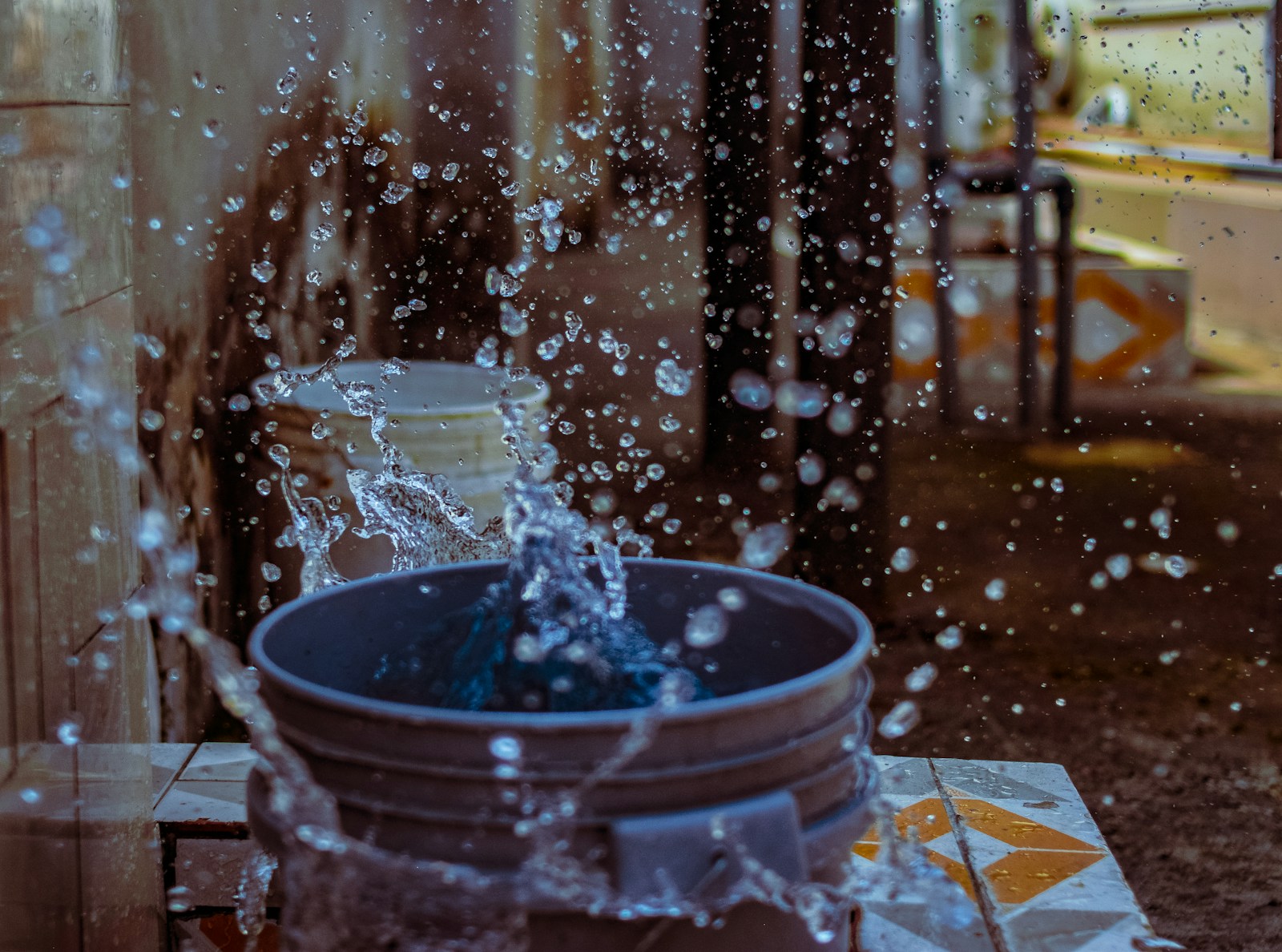 gray plastic bucket with water