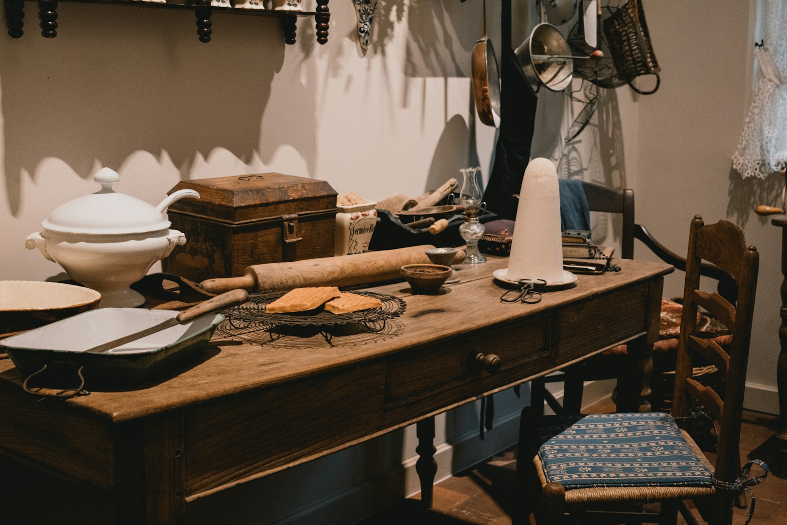 Wooden table with baking supplies and vintage kitchen items.