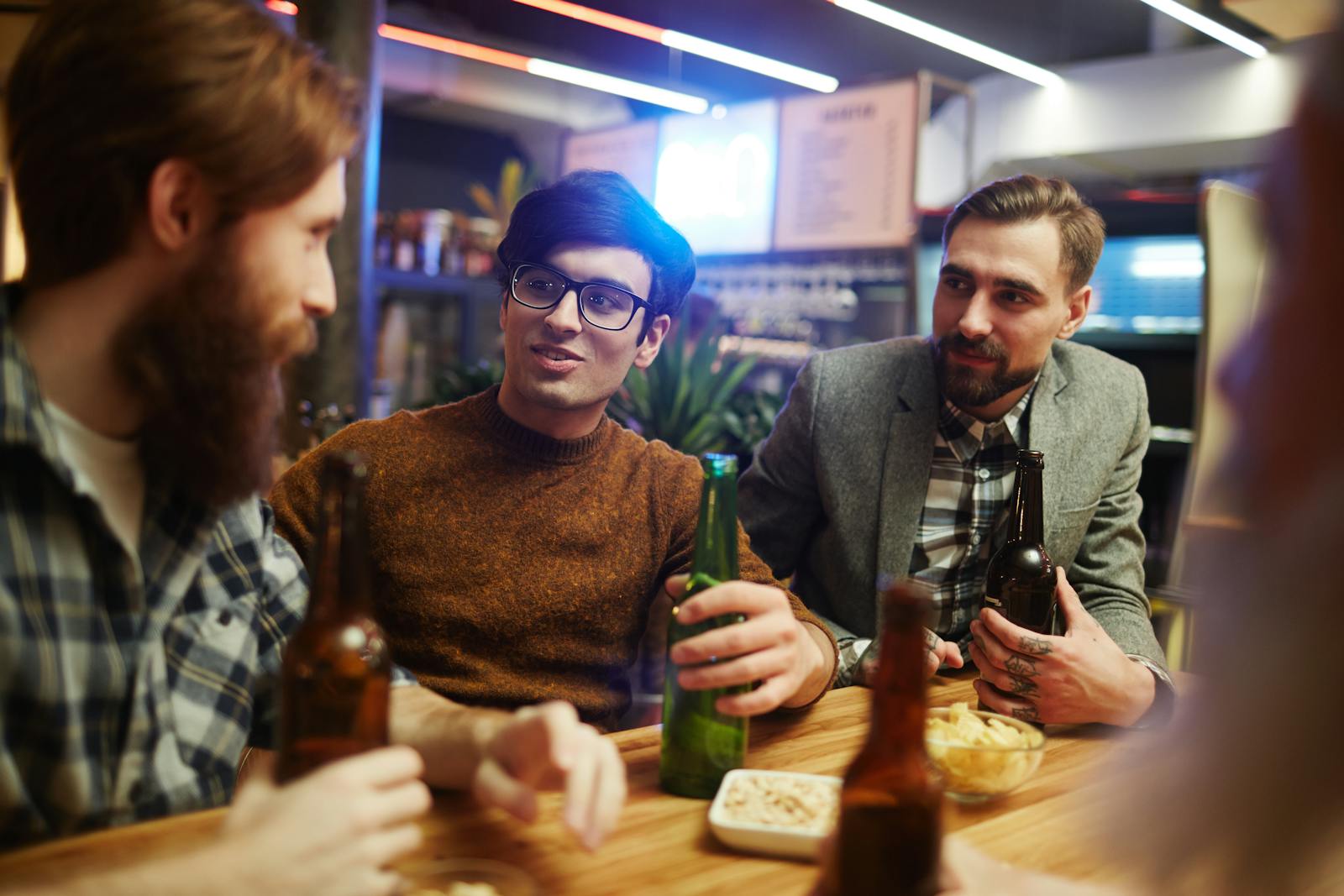 A group of friends enjoying drinks and conversation in a cozy pub.