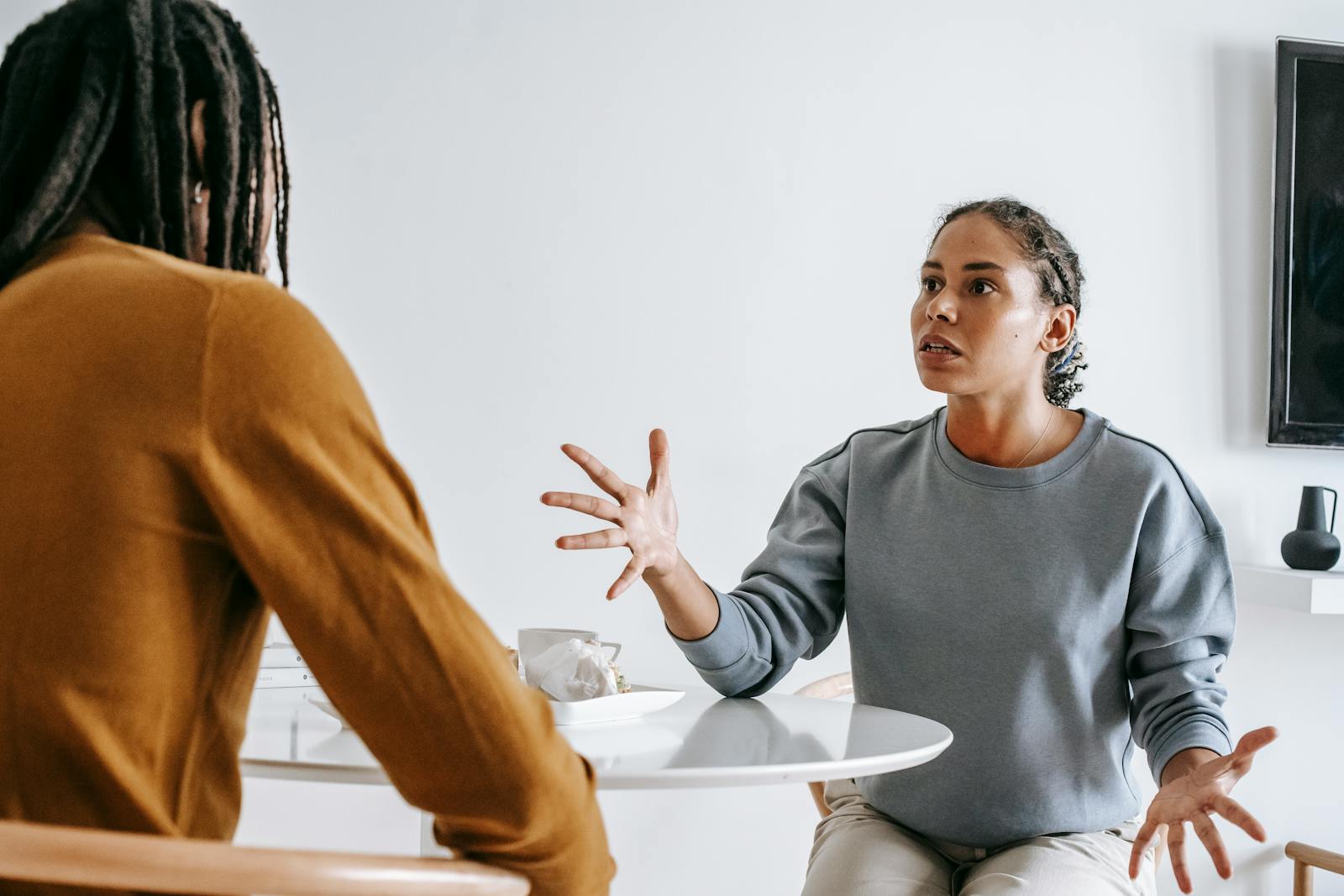 A couple engaged in a serious discussion at a home table.