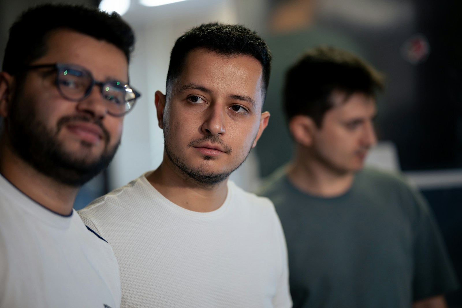 Two men standing next to each other in a room