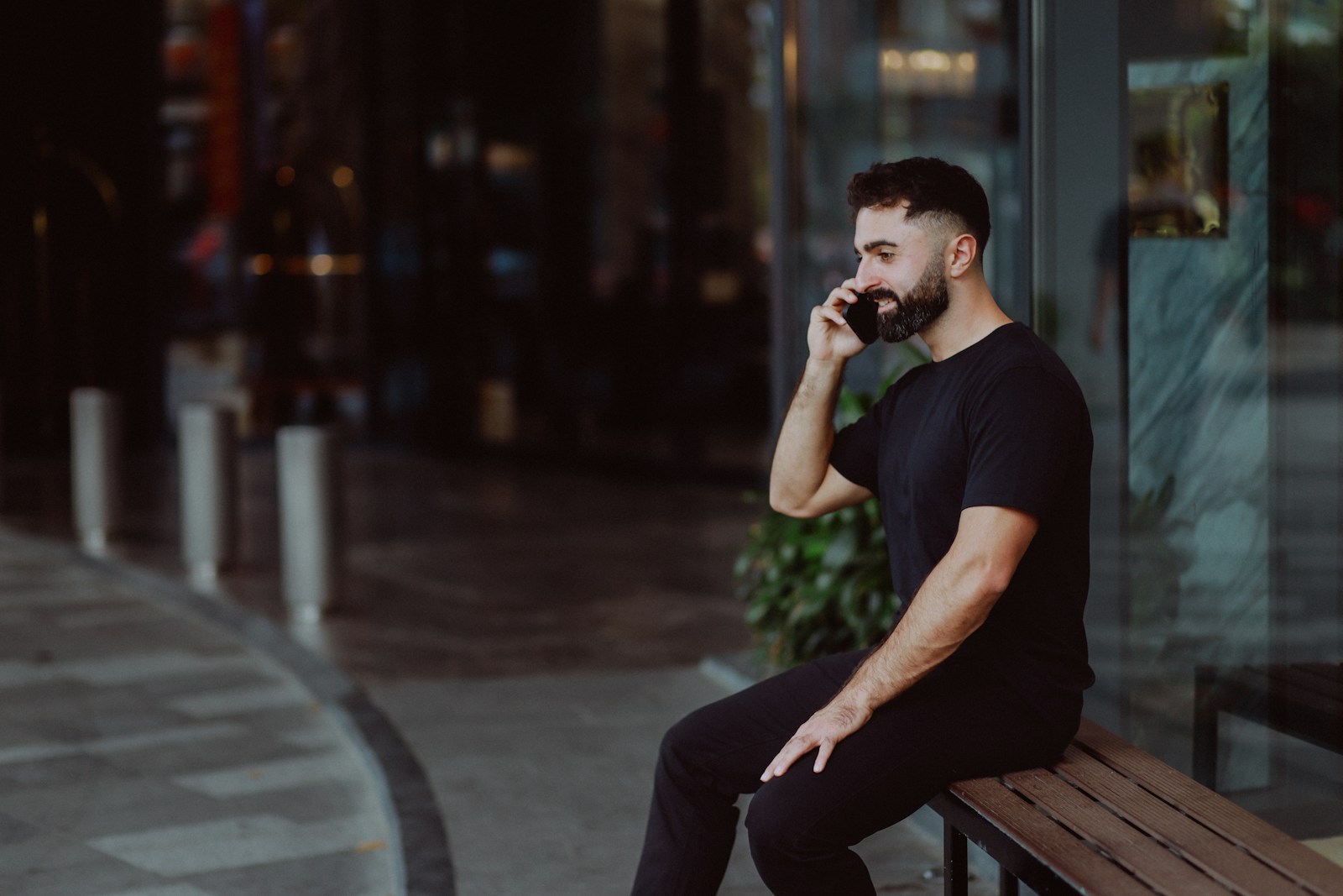 Man in black talking on phone at night