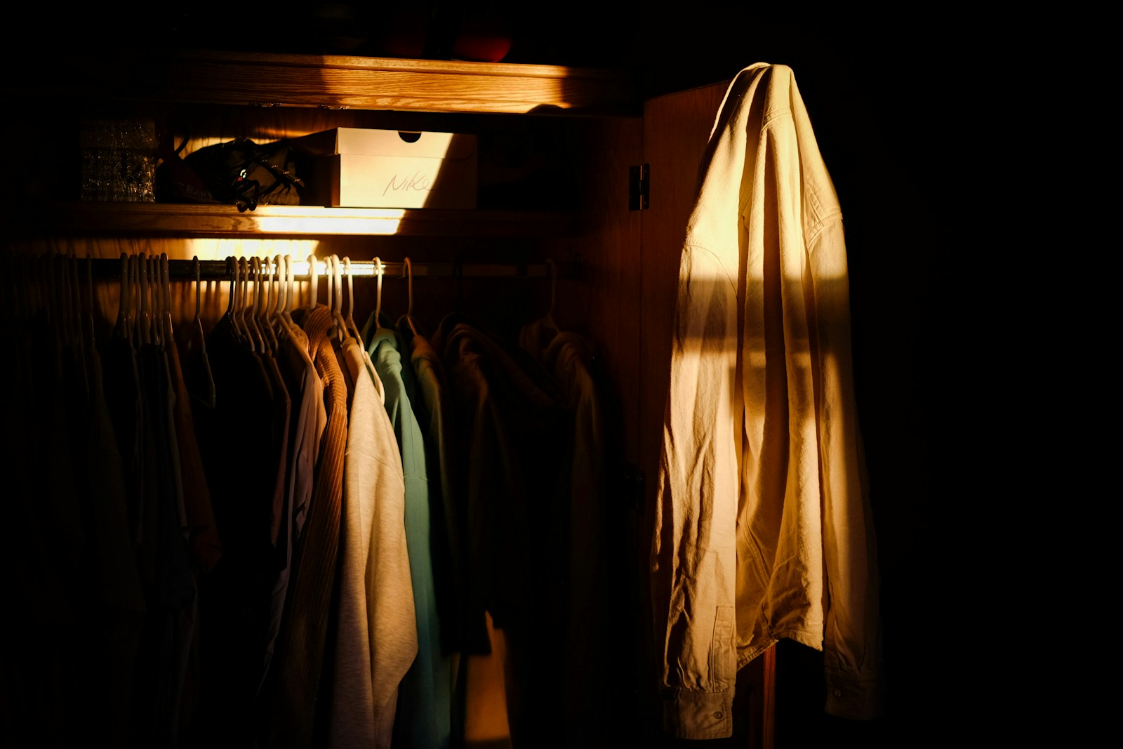 A closet with clothes hanging on a rail