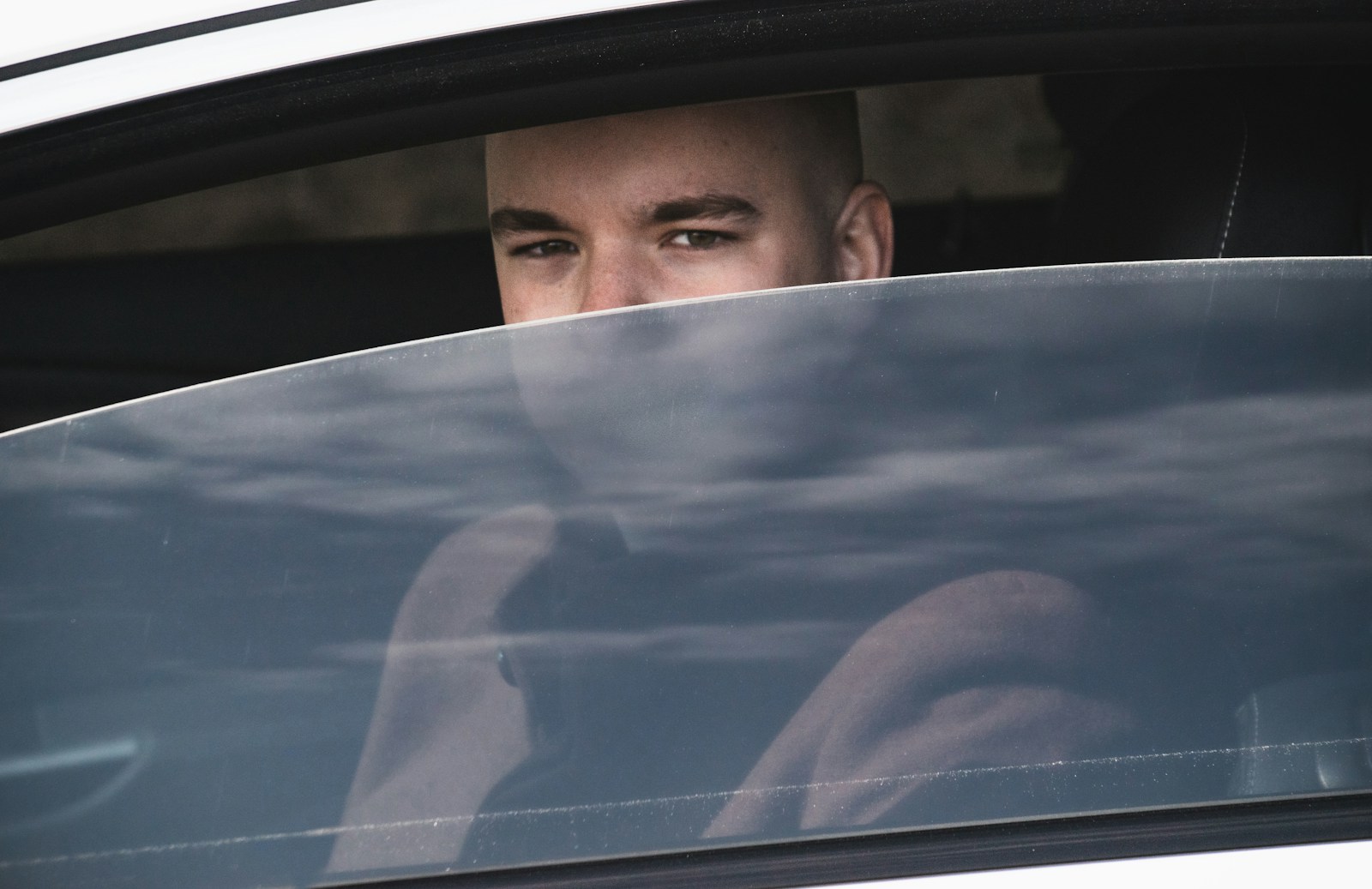 Man looks out of a car window.