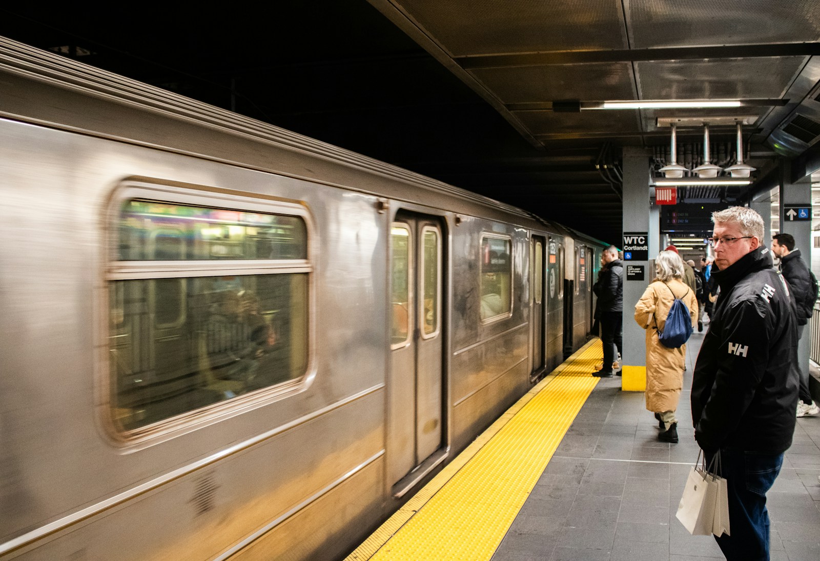 A subway train waits at the station.