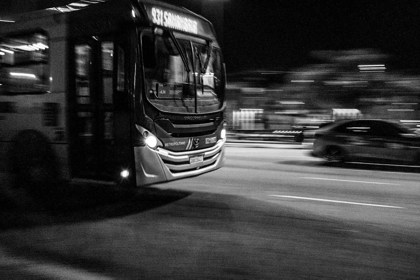Bus moving fast on a city street at night