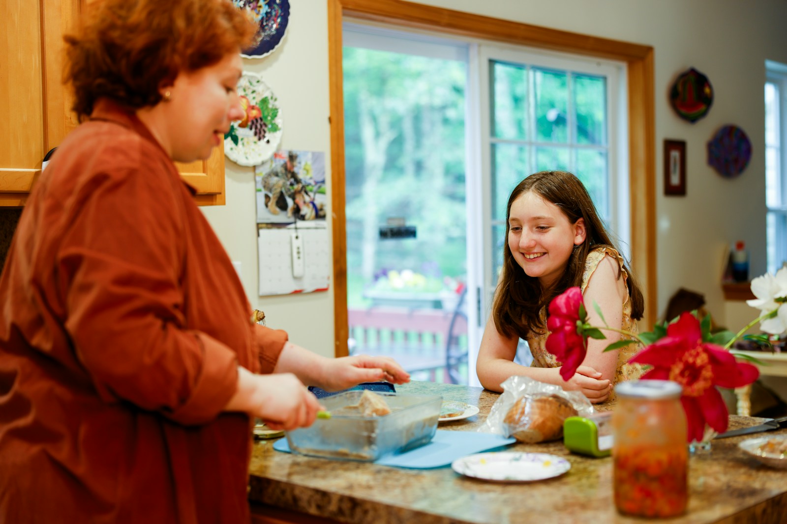 Woman preparing food with a girl watching
