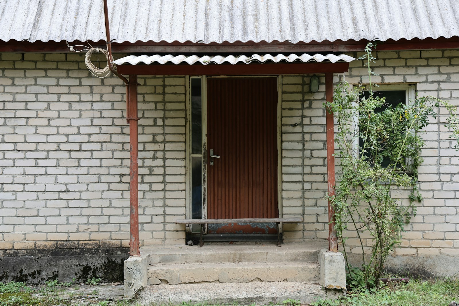 Entrance to a brick building with a brown door.