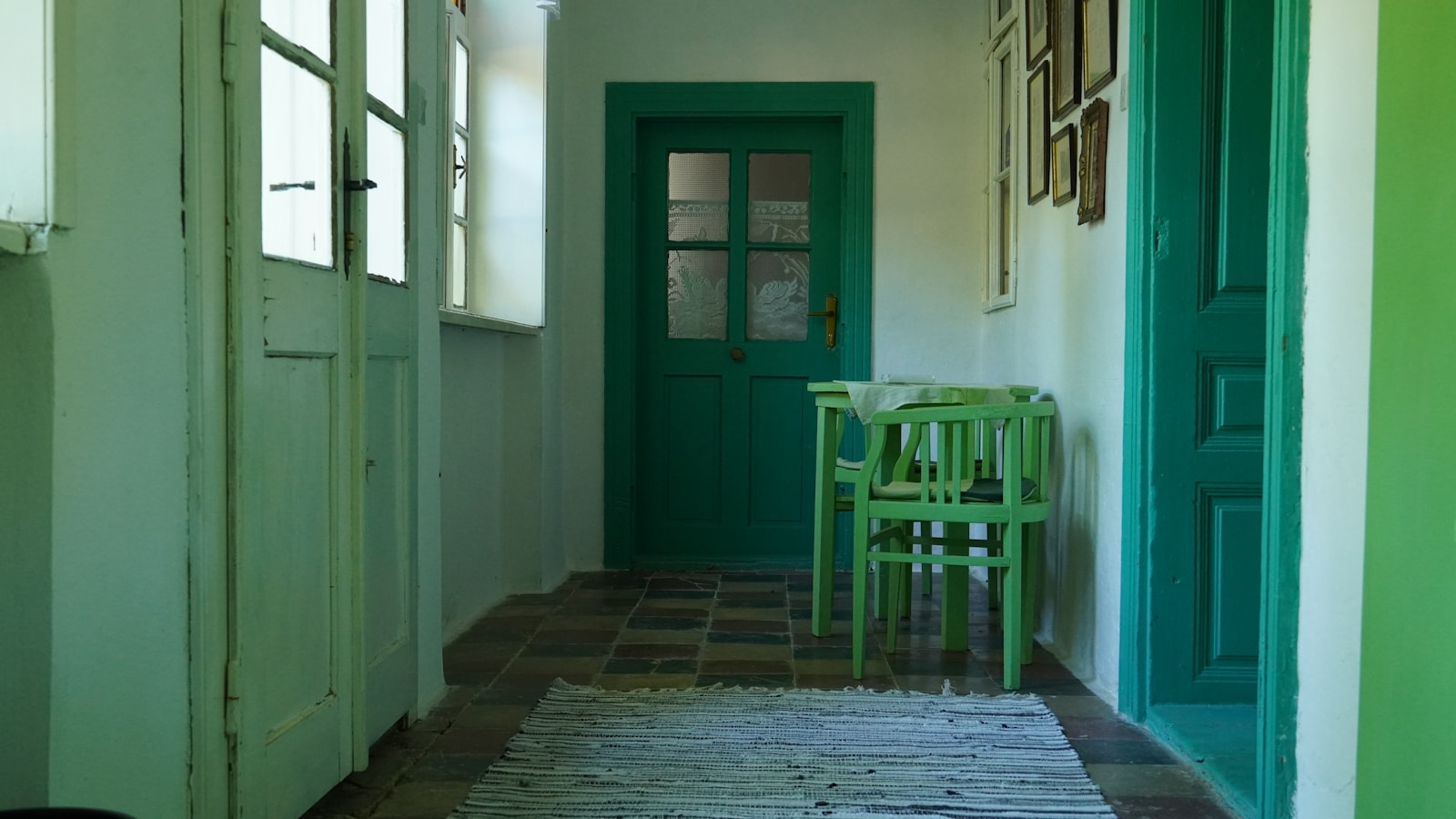 a room with green doors and a table