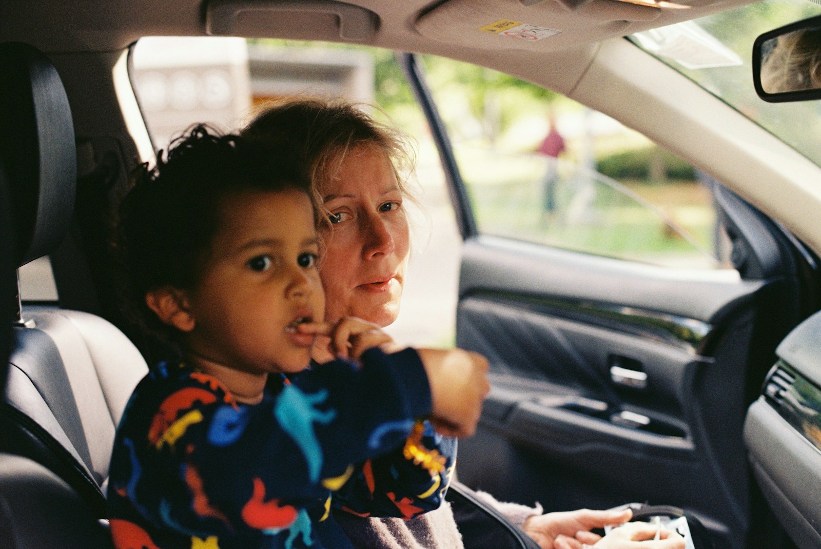 a person and a child in a car