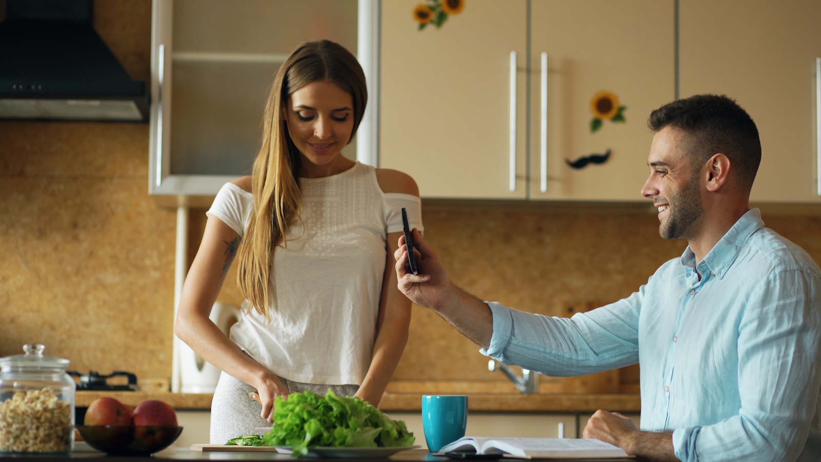 Couple taking a selfie while cooking in kitchen