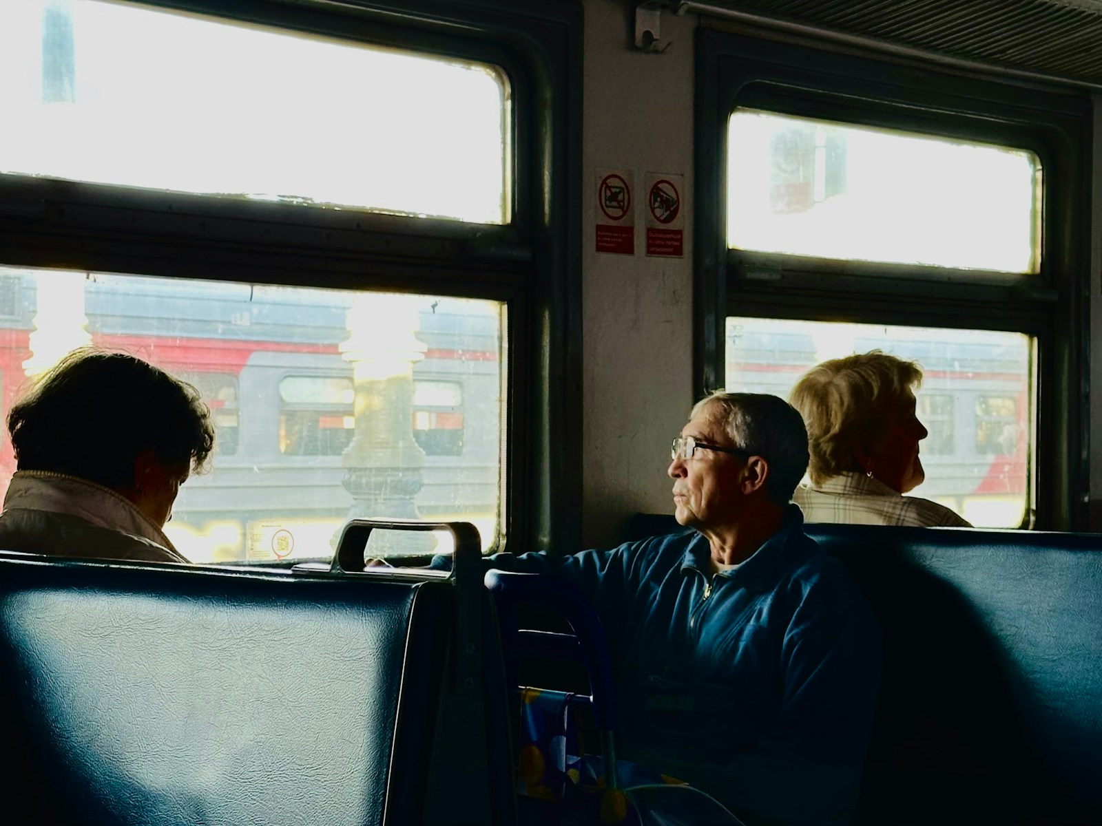 A group of people sitting on a bus next to each other