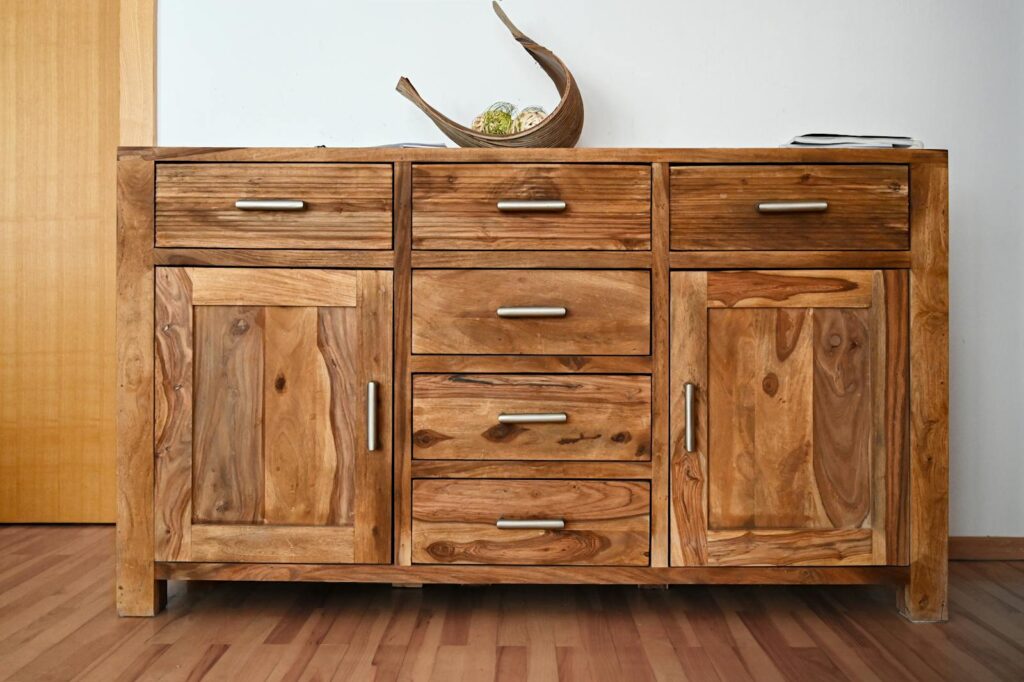 Beautiful wooden cabinet with sleek handles and natural wood grain, ideal for stylish interiors.