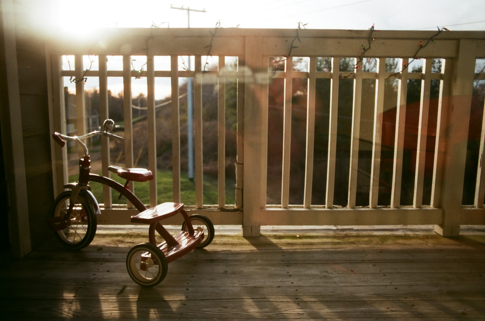 a small wooden tricycle sitting on a porch